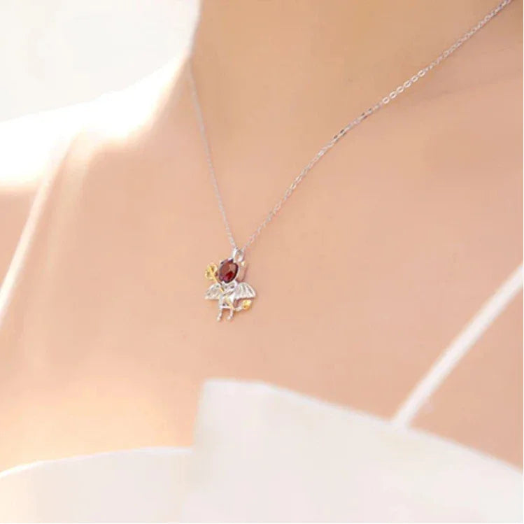 Garnet Devil and Wing Pendant Necklace worn at the neckline in a close-up