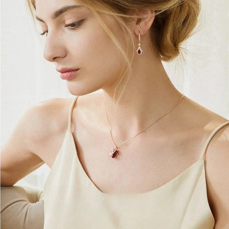 Garnet Filigree Teardrop Earrings angled product detail on a jewelry display