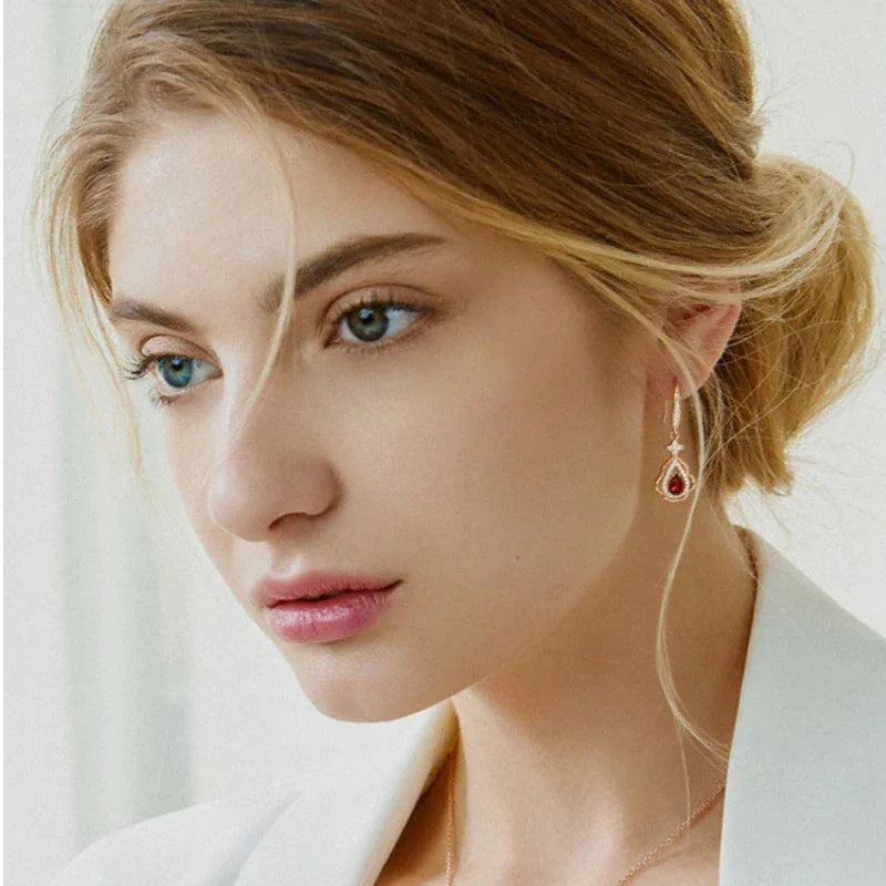 Garnet Filigree Teardrop Earrings worn on the hand from a second angle