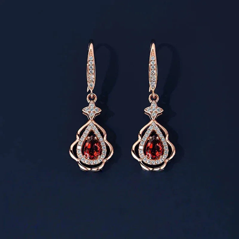 Garnet Filigree Teardrop Earrings worn on the hand in a close-up