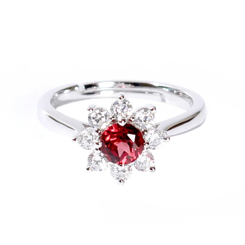 Garnet Floral Halo Adjustable Ring side view held between the fingers