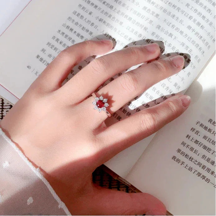 Garnet Floral Halo Adjustable Ring worn on the hand in a close-up