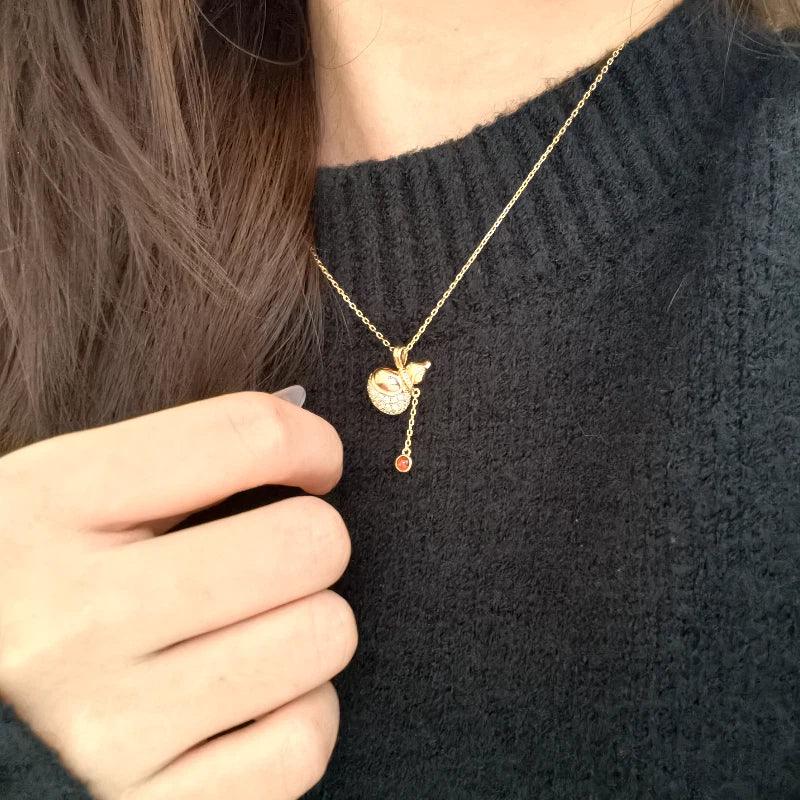 Garnet Gourd Drop Pendant Necklace worn at the neckline in a close-up