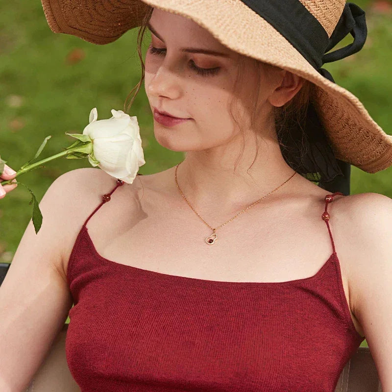 Garnet Gourd Halo Pendant Necklace worn at the neckline from a second angle