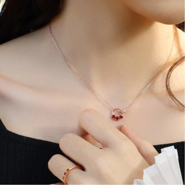 Garnet Interlocking Circle Pendant Necklace worn at the neckline from a second angle