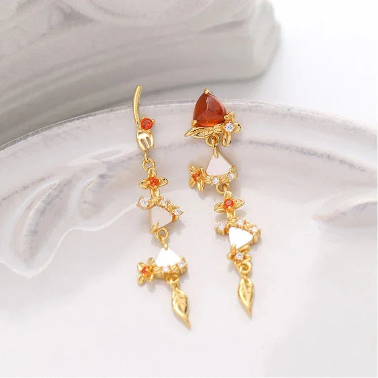 Garnet Leaf Cascade Drop Earrings angled product detail on a jewelry display