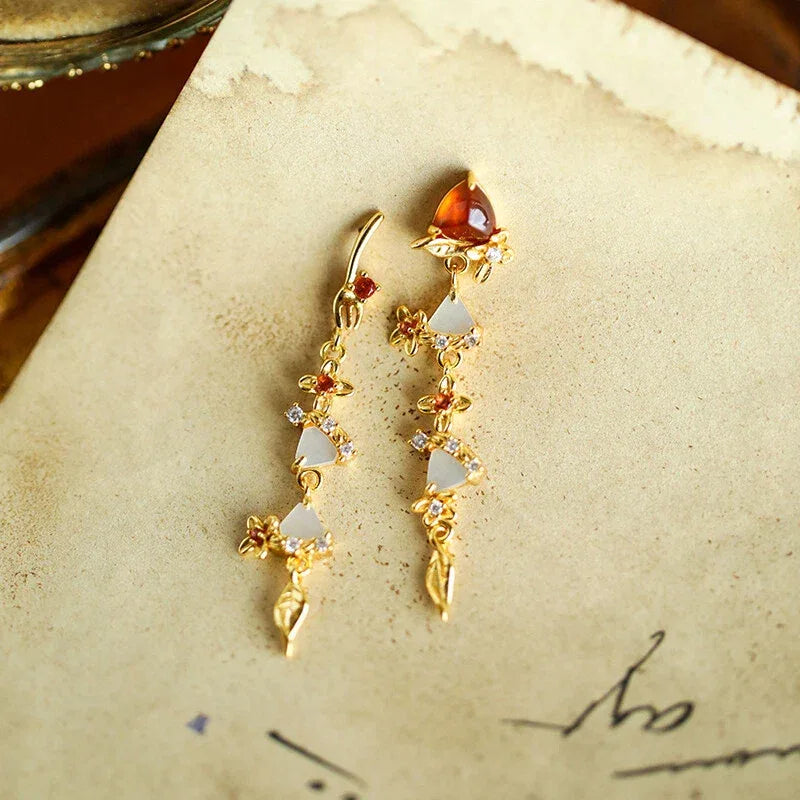 Garnet Leaf Cascade Drop Earrings side view held between the fingers