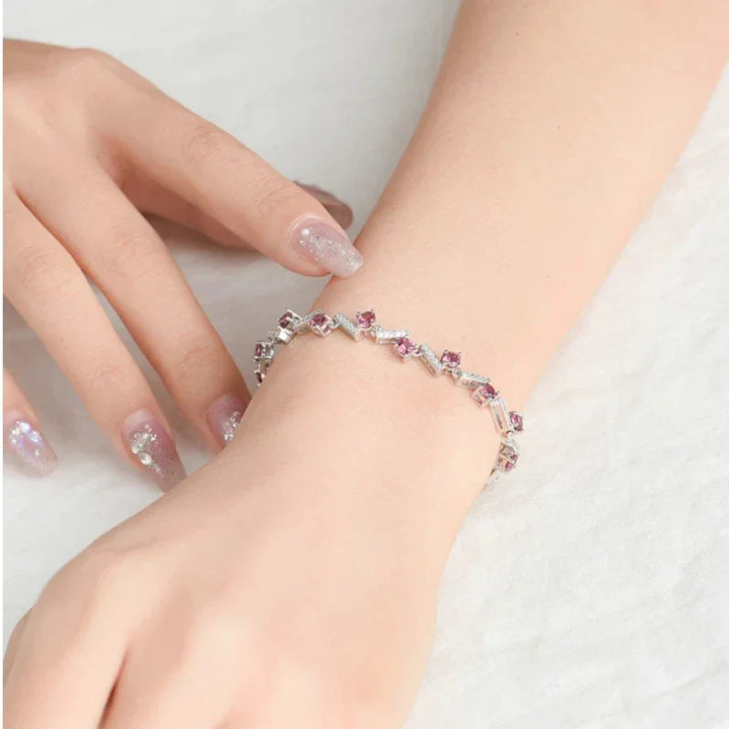 Garnet Leaf-Link Tennis Bracelet worn on the wrist in a close-up