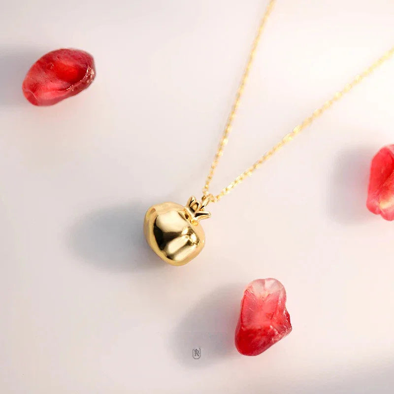 Garnet Pomegranate Pendant Necklace pendant styled on a jewelry display