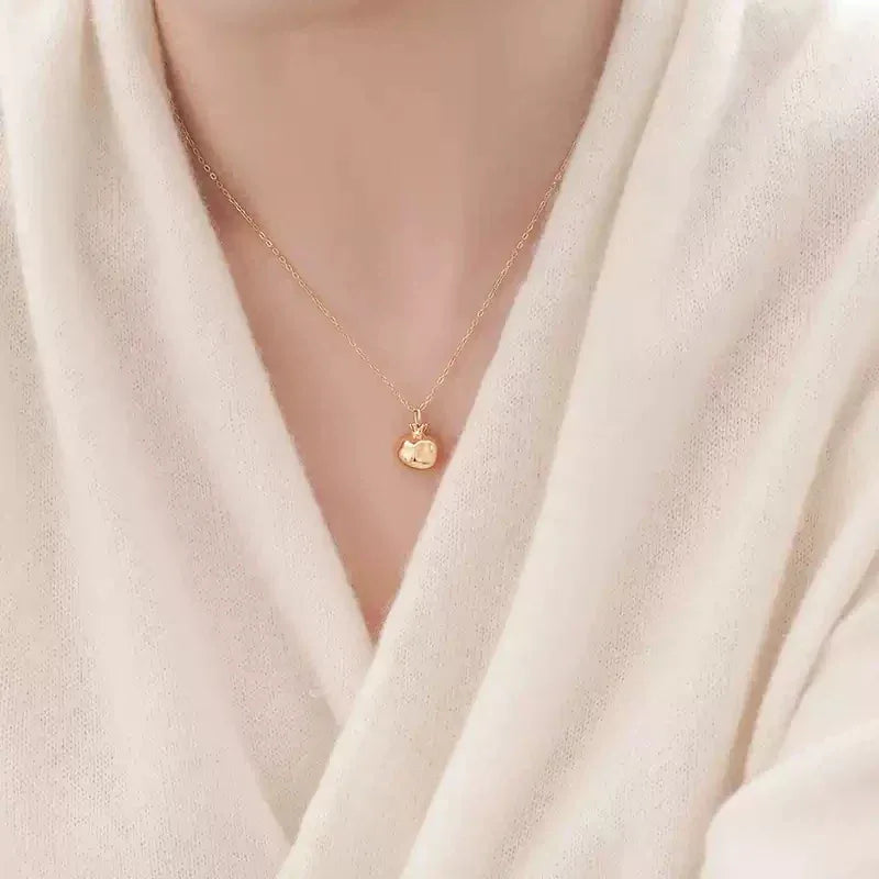 Garnet Pomegranate Pendant Necklace worn at the neckline from a second angle