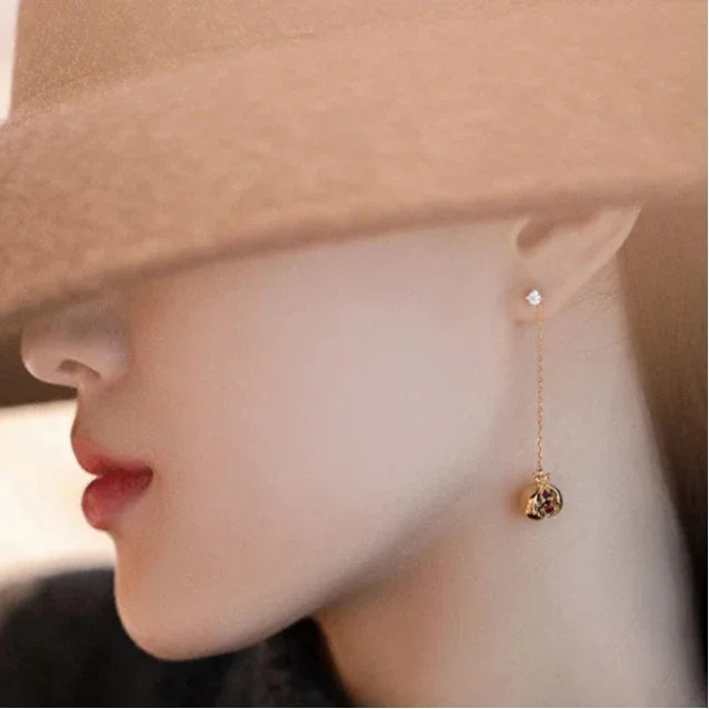 Garnet Pomegranate Threader Earrings worn on the hand from a second angle