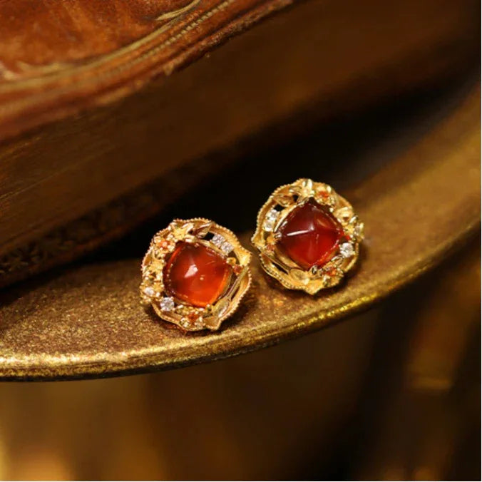 Garnet Rope-Halo Stud Earrings angled product detail on a jewelry display