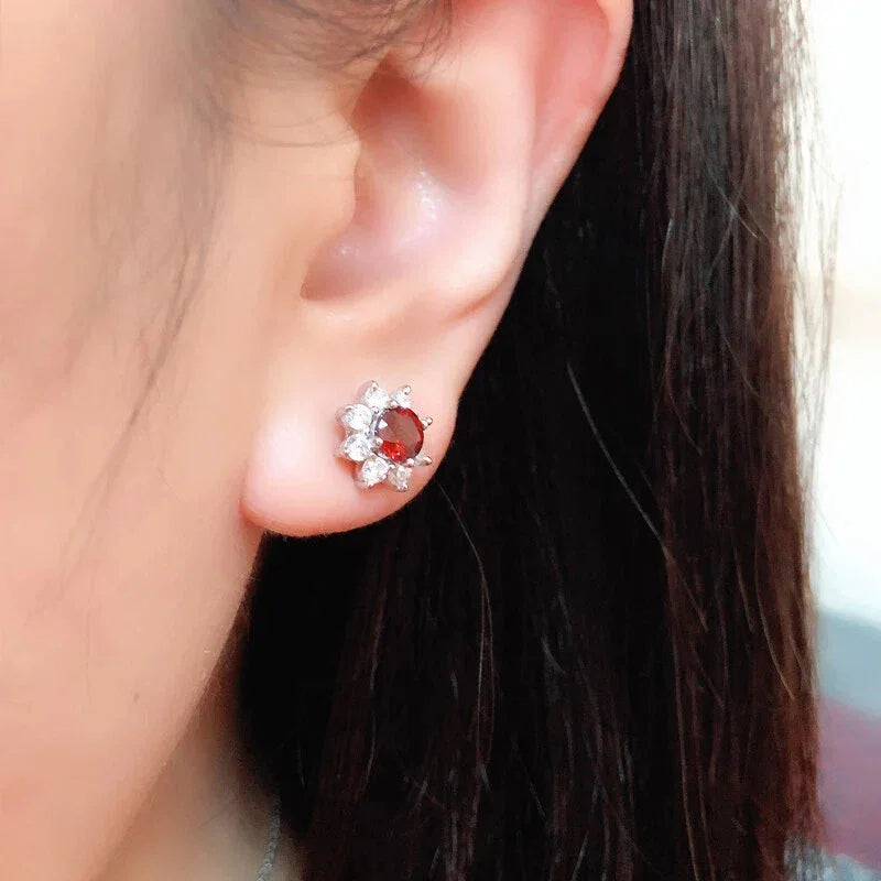 Garnet Snowflake Stud Earrings worn on the hand from a second angle