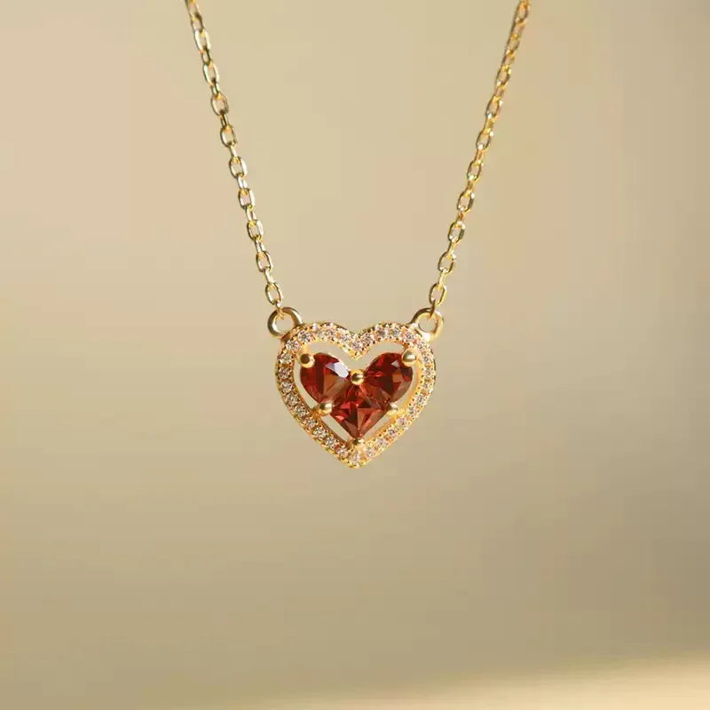 Garnet Triple-Stone Heart Necklace close-up of the pendant and chain