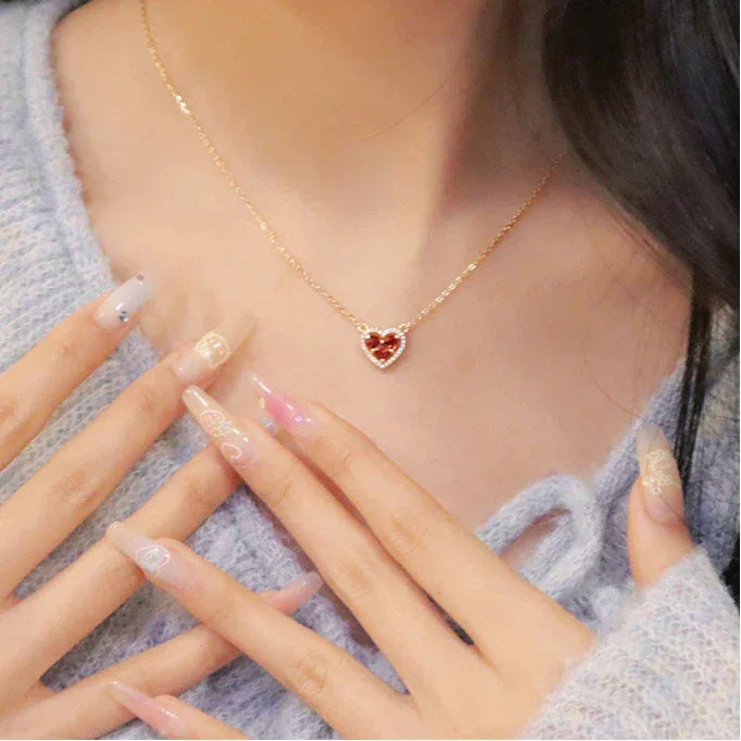Garnet Triple-Stone Heart Necklace worn at the neckline from a second angle