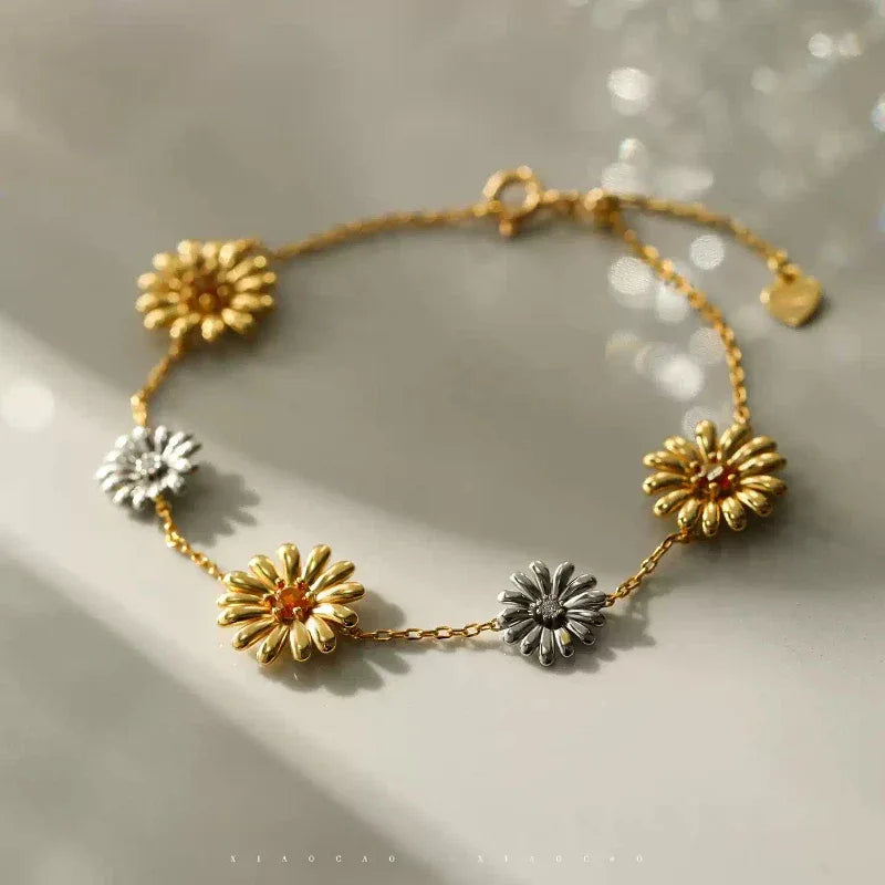 Garnet Two-Tone Floral Station Bracelet worn on the wrist from a second angle