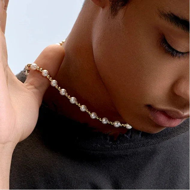 Gold-Plated Brass and Pearl Beaded Necklace — model adjusting the necklace near the collar