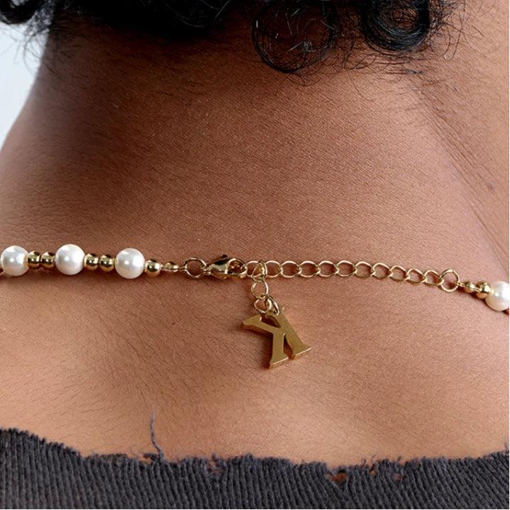 Gold-Plated Brass and Pearl Beaded Necklace — rear-neck worn view showing the extension chain and charm