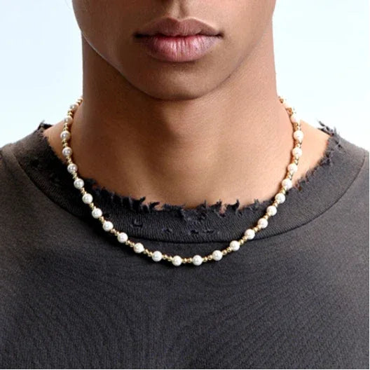 Gold-Plated Brass and Pearl Beaded Necklace — necklace layered with a second chain on a dark shirt