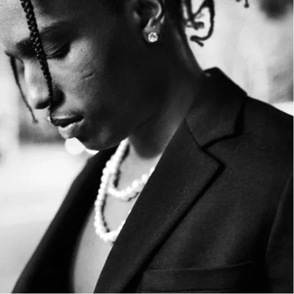 Classic Pearl Strand Necklace — black-and-white portrait wearing the necklace with a blazer