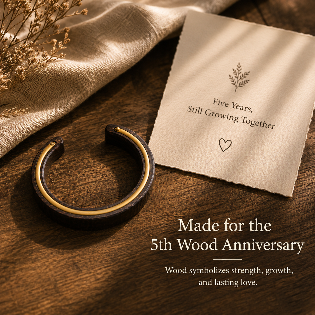 Handmade Ebony Wood & Brass Cuff Bracelet, styled product scene with anniversary-themed props
