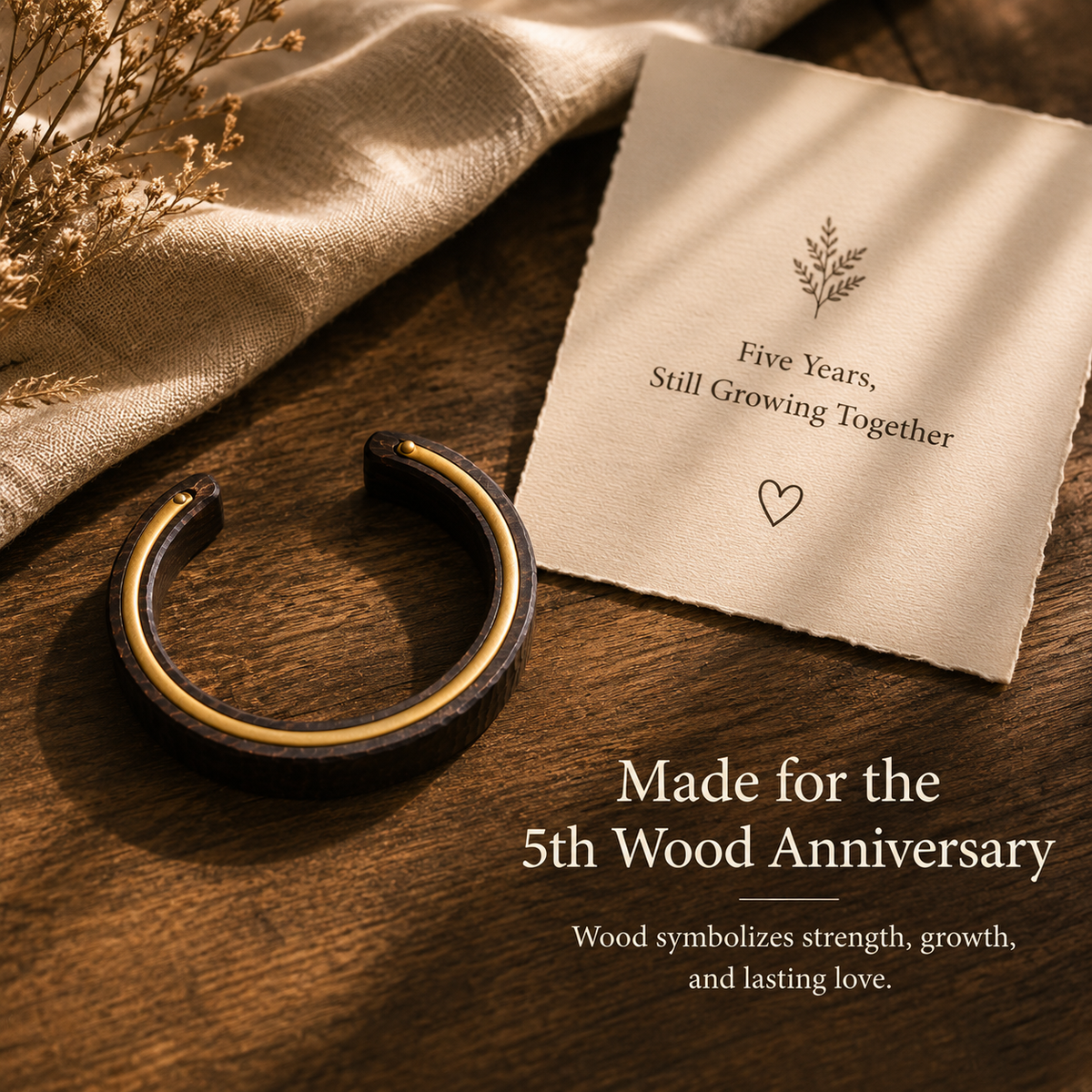 Handmade Ebony Wood & Brass Cuff Bracelet, styled product scene with anniversary-themed props