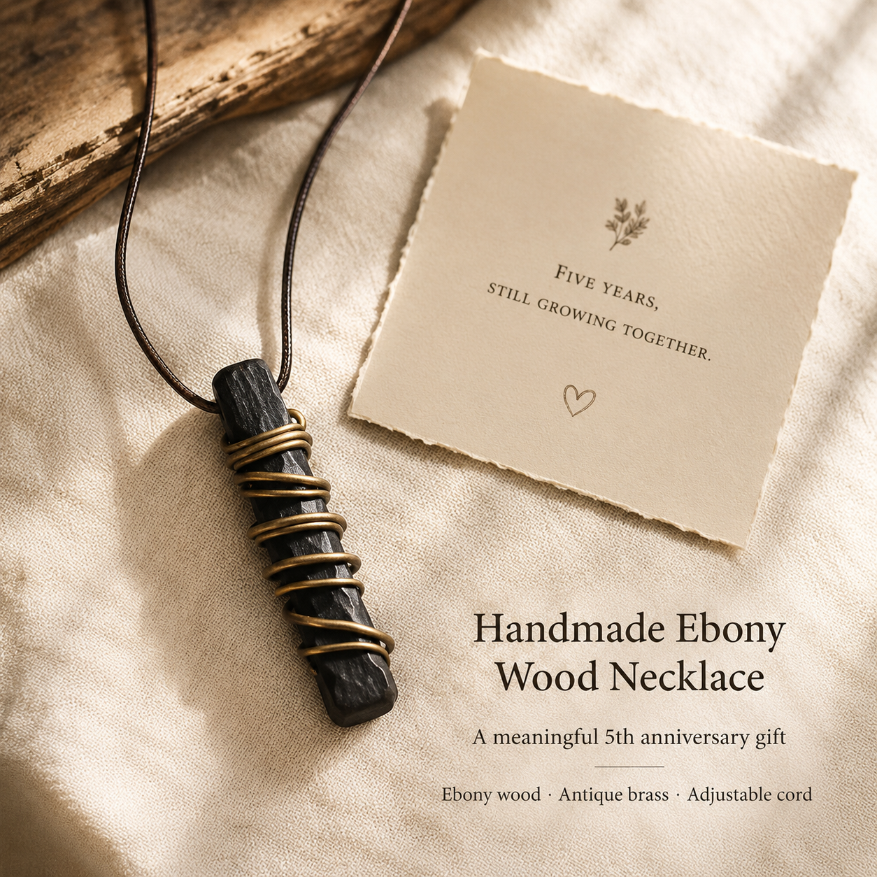 Handmade Ebony Wood & Antique Brass Pendant Necklace, styled product scene with anniversary-themed props