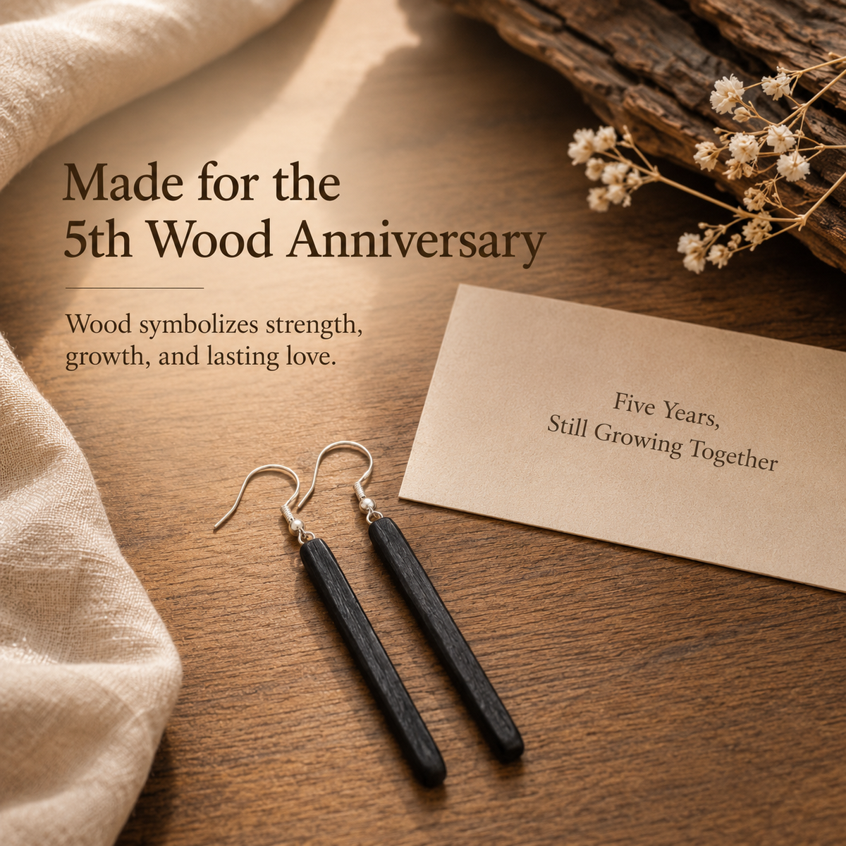 Handmade Ebony Wood Long Drop Earrings, styled product scene with anniversary-themed props