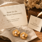 Handwoven Bamboo Flower Pearl Drop Earrings, styled product scene with anniversary-themed props