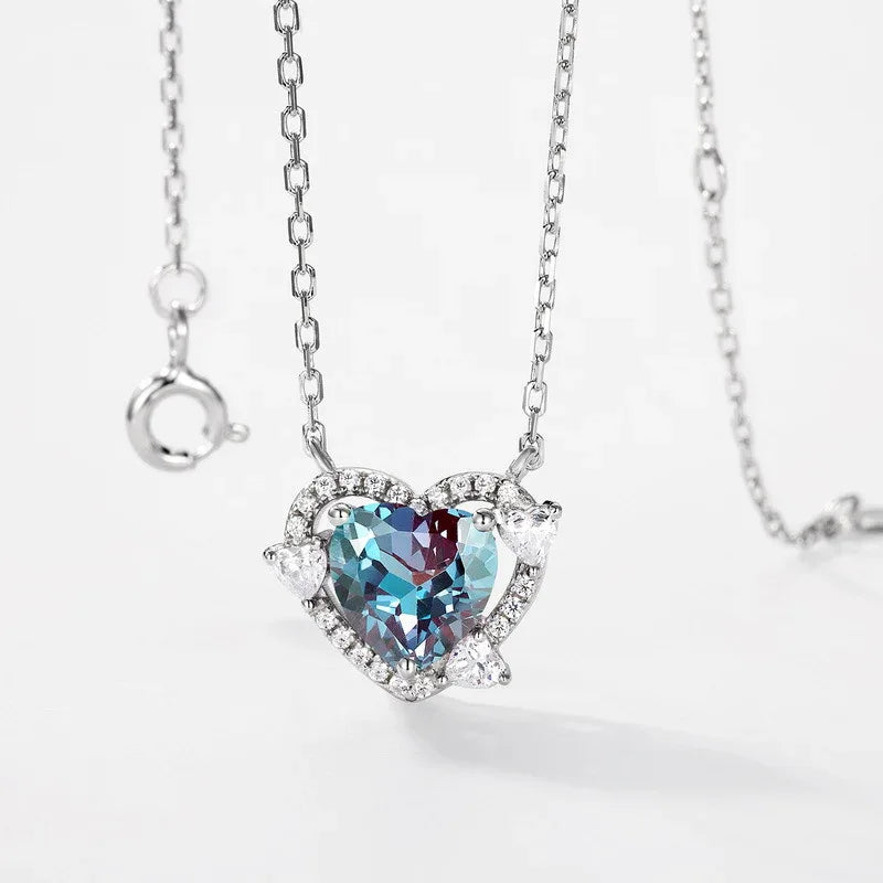Heart Alexandrite halo pendant necklace with clear accents, center stone close-up on a white background
