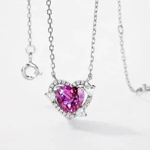 Heart Alexandrite halo pendant necklace with clear accents, pink-toned Alexandrite view under alternate lighting