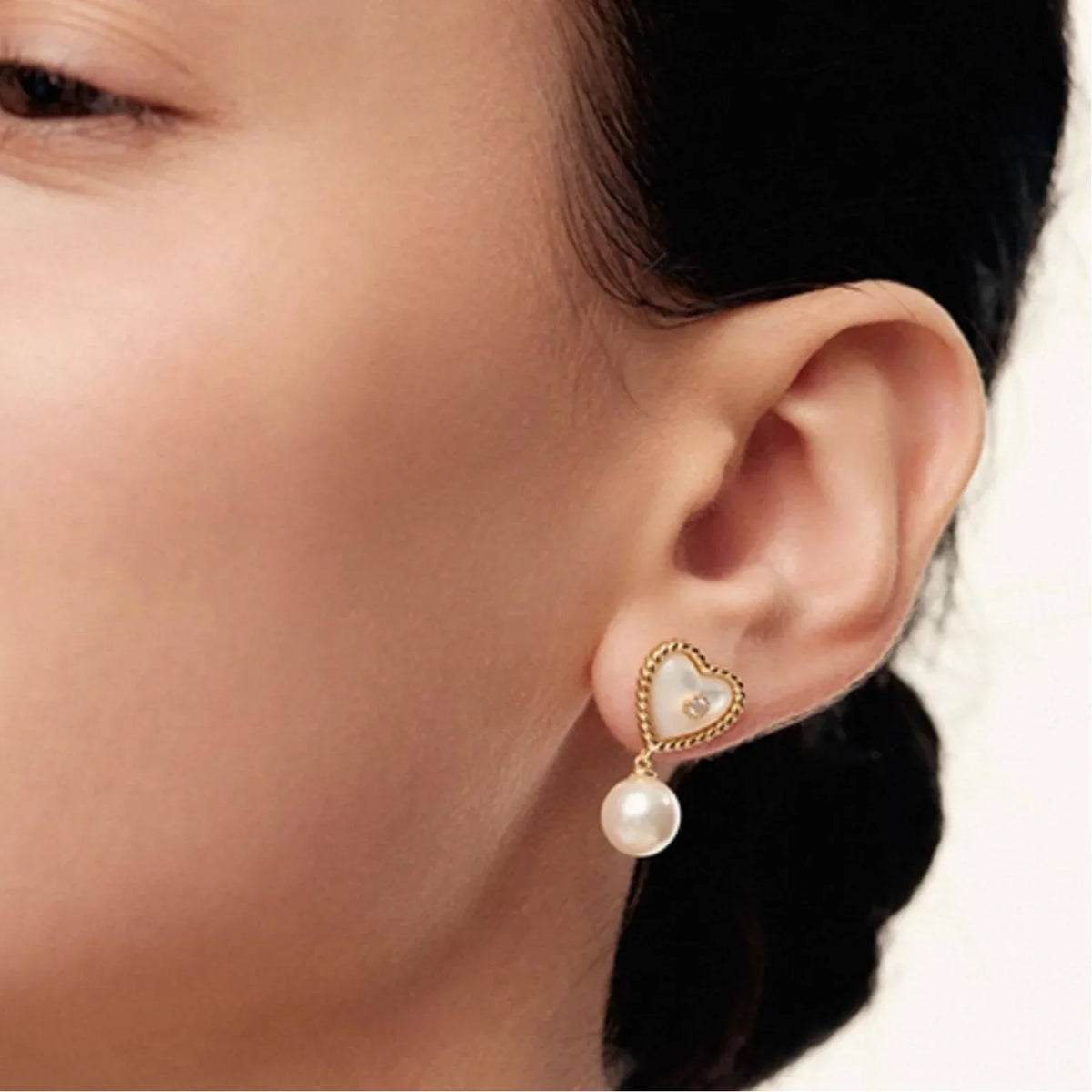 Pearl Drop Heart Earrings with Clear Center Accents — left-ear worn close-up showing the two-part drop scale