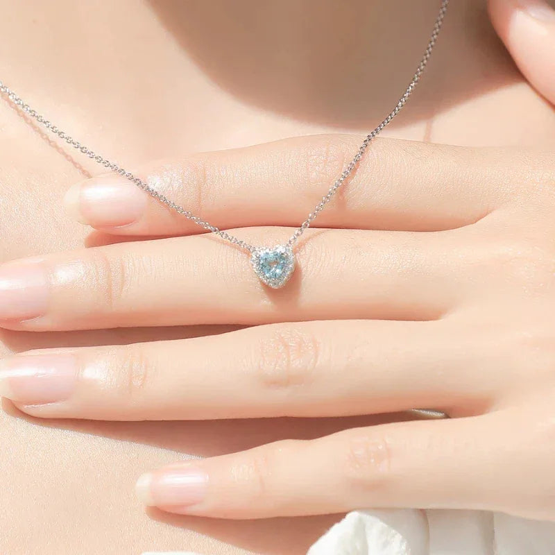 Heart-Cut Aquamarine Halo Pendant Necklace worn at the neckline in a close-up