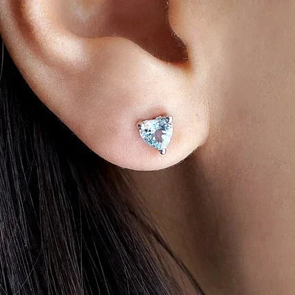 Heart-Cut Aquamarine Stud Earrings worn on the ear in a close-up