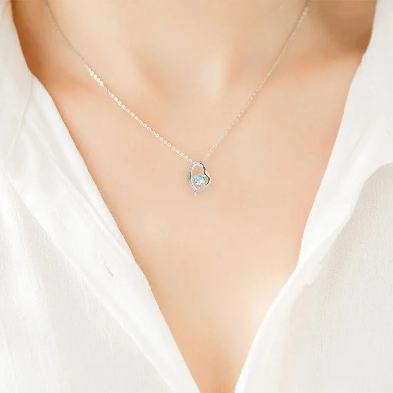 Heart-Cut Aquamarine Swirl Pendant Necklace worn at the neckline in a close-up
