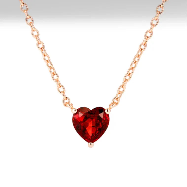 Heart-Cut Garnet Solitaire Necklace pendant styled on a jewelry display