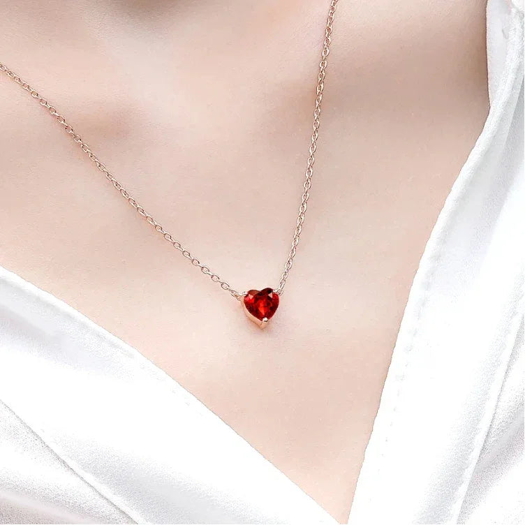 Heart-Cut Garnet Solitaire Necklace worn at the neckline in a close-up