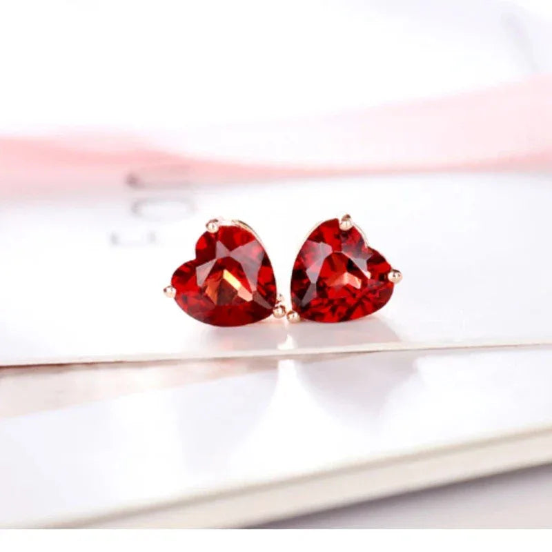 Heart-Cut Garnet Stud Earrings angled product detail on a jewelry display