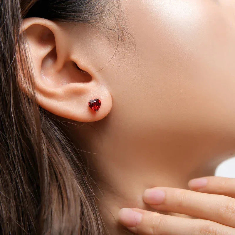 Heart-Cut Garnet Stud Earrings worn on the hand from a second angle