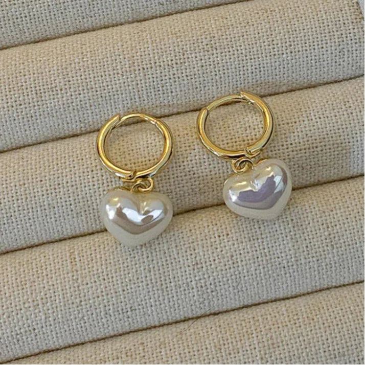 Pearl Heart Drop Huggie Earrings — earrings displayed in a beige jewelry tray