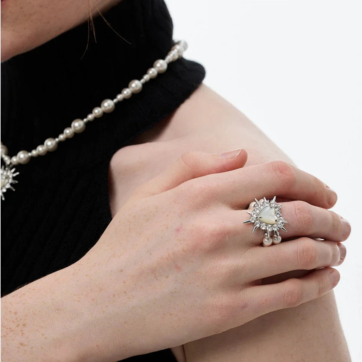 Spiked Pearl Cluster Statement Ring — alternate hand-worn view over a black sleeve