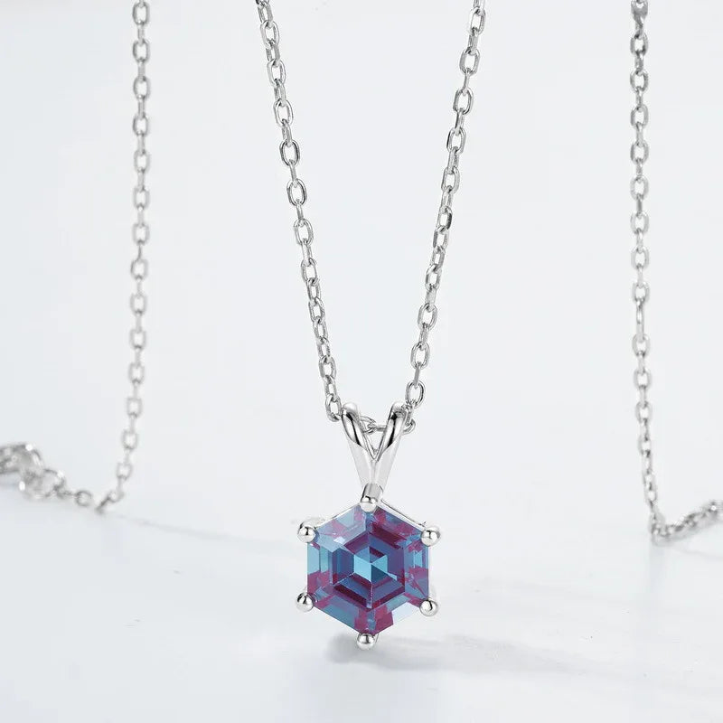 Hexagon Alexandrite pendant necklace with a three-bar bail, product laid flat on a white background