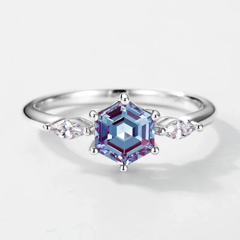 Hexagon Alexandrite ring with marquise-shaped clear accents, center stone close-up on a white background
