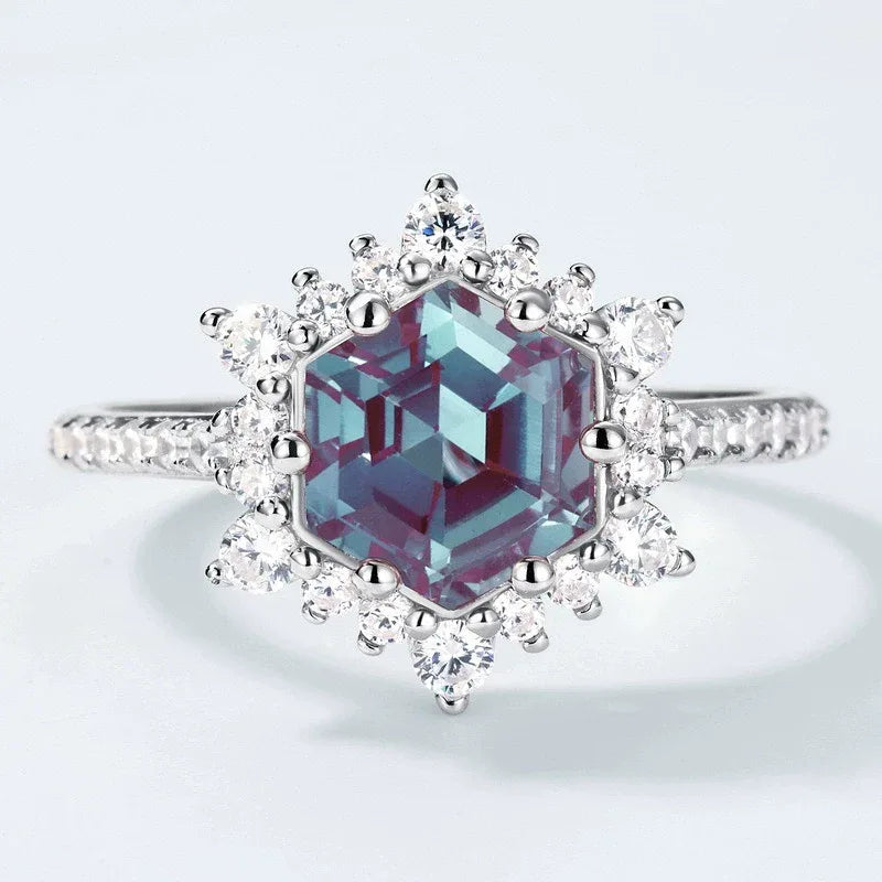 Hexagon Alexandrite sunburst halo ring, center stone close-up on a white background