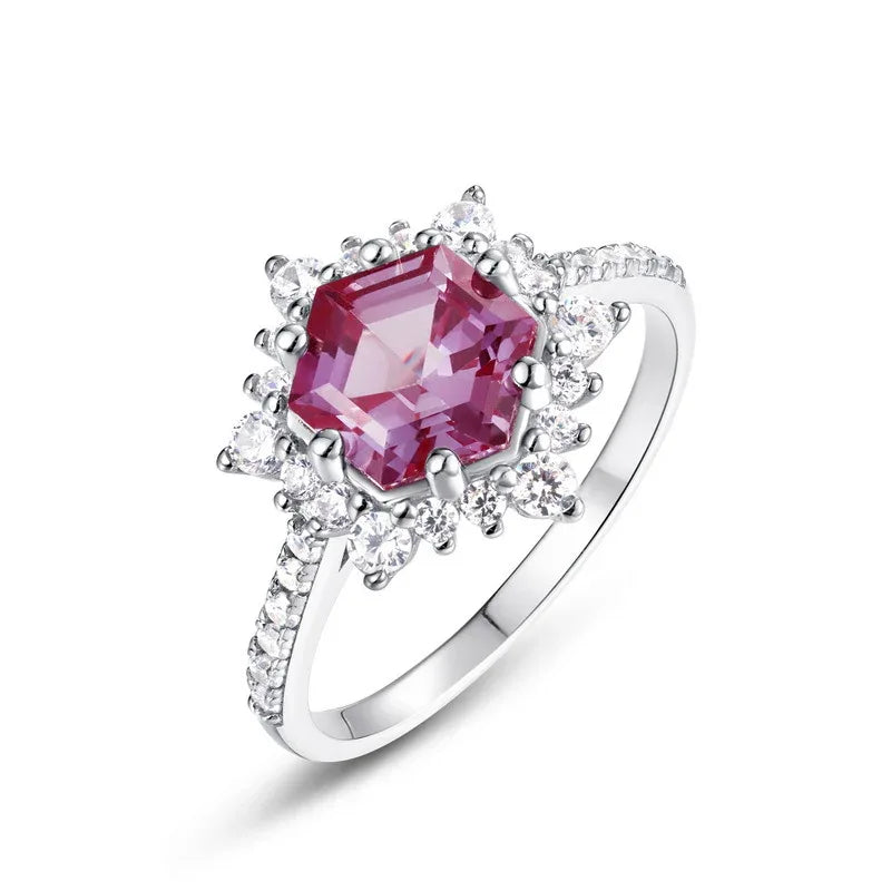 Hexagon Alexandrite sunburst halo ring, pink-toned Alexandrite view under alternate lighting