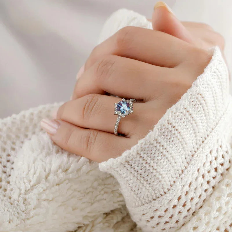Hexagon Alexandrite sunburst halo ring, alternate shown worn in a close lifestyle view
