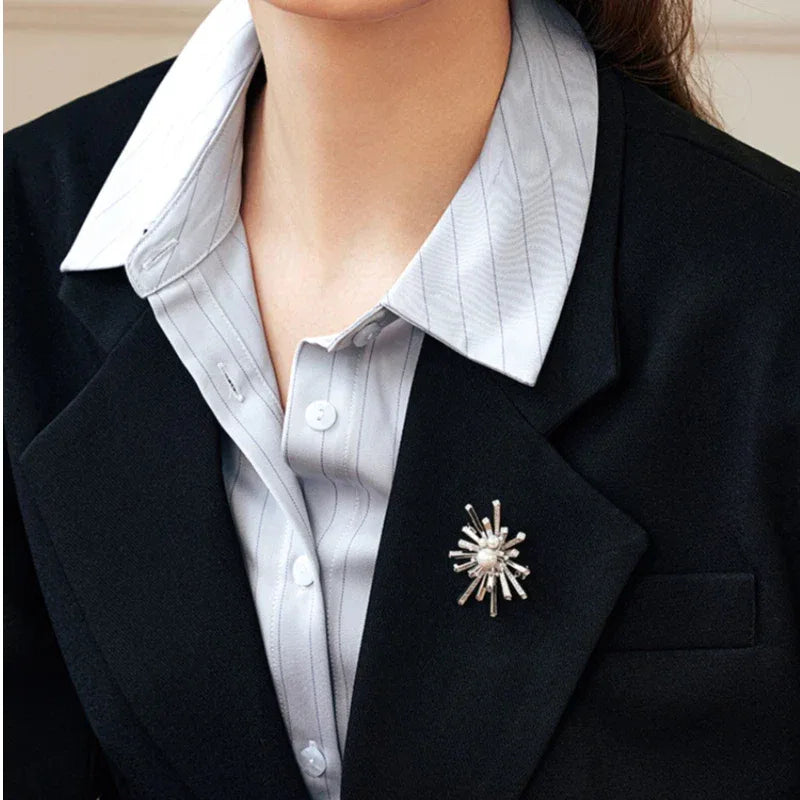 Pearl Starburst Snowflake Brooch — waist-up blazer-worn view showing scale