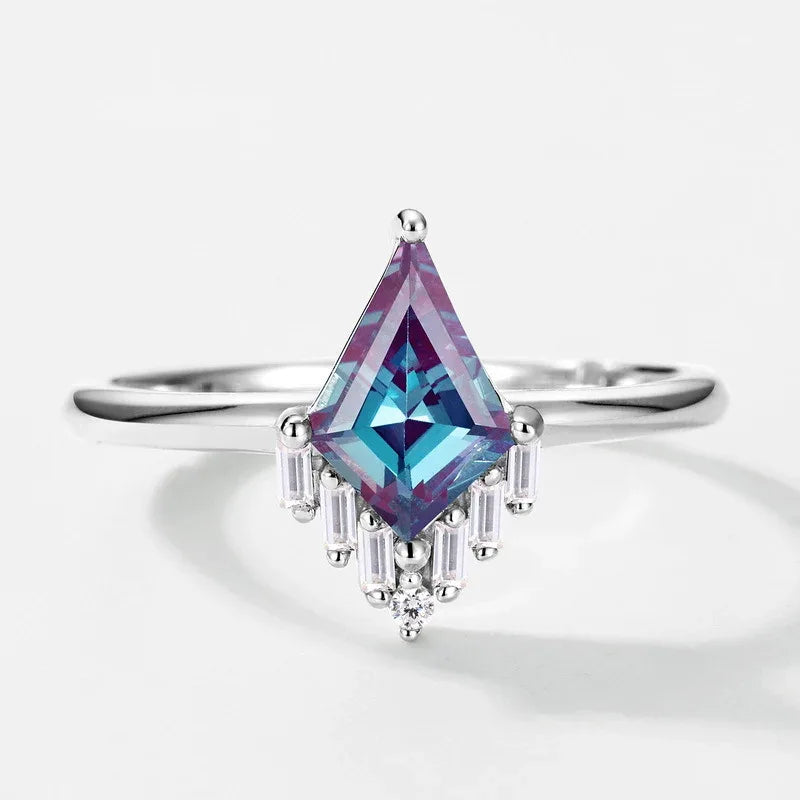 Kite-cut Alexandrite ring with a clear drop accent, center stone close-up on a white background