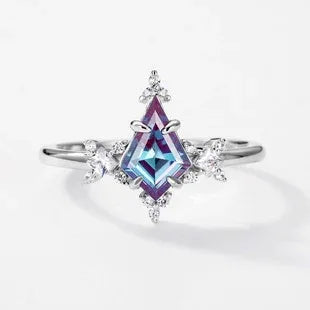 Kite-cut Alexandrite ring with clear halo accents, center stone close-up on a white background