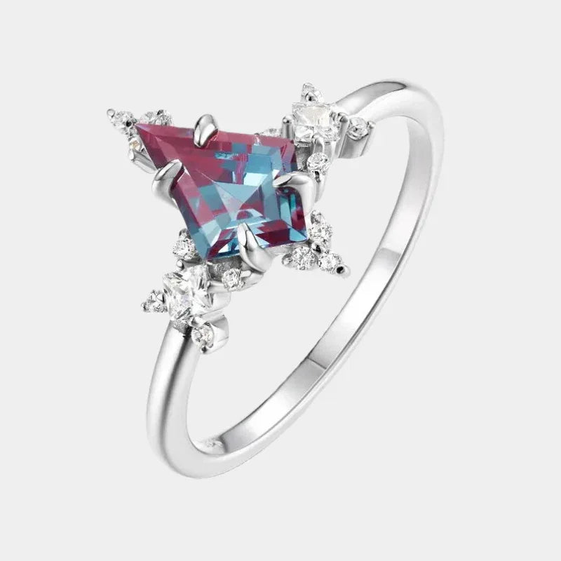 Kite-cut Alexandrite ring with clear halo accents, front product view on a white background